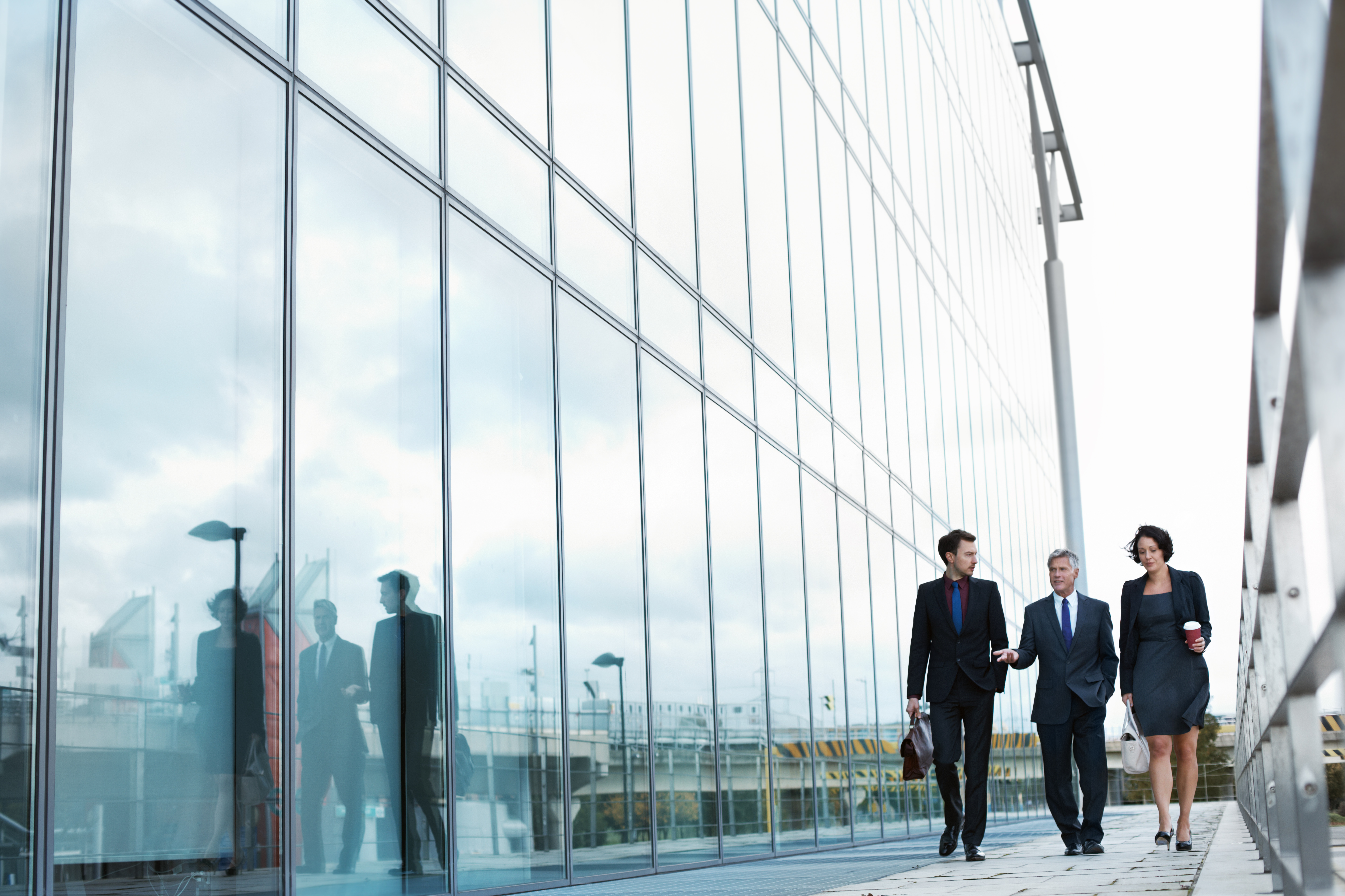 Professionals walking next to skyscraper